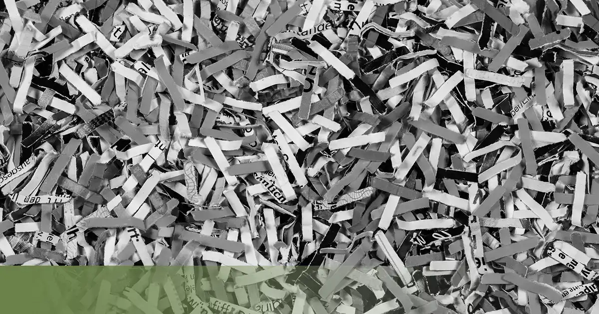 Confidential documents being securely shredded with Certificate of Destruction
